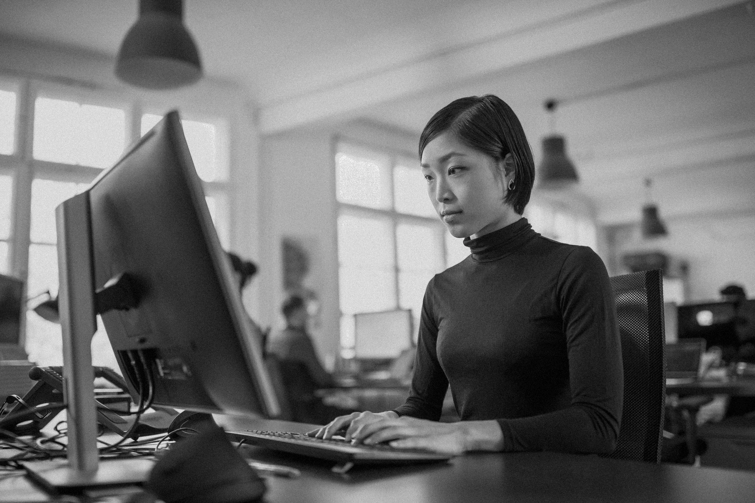 Someone working at a workstation in a bright office