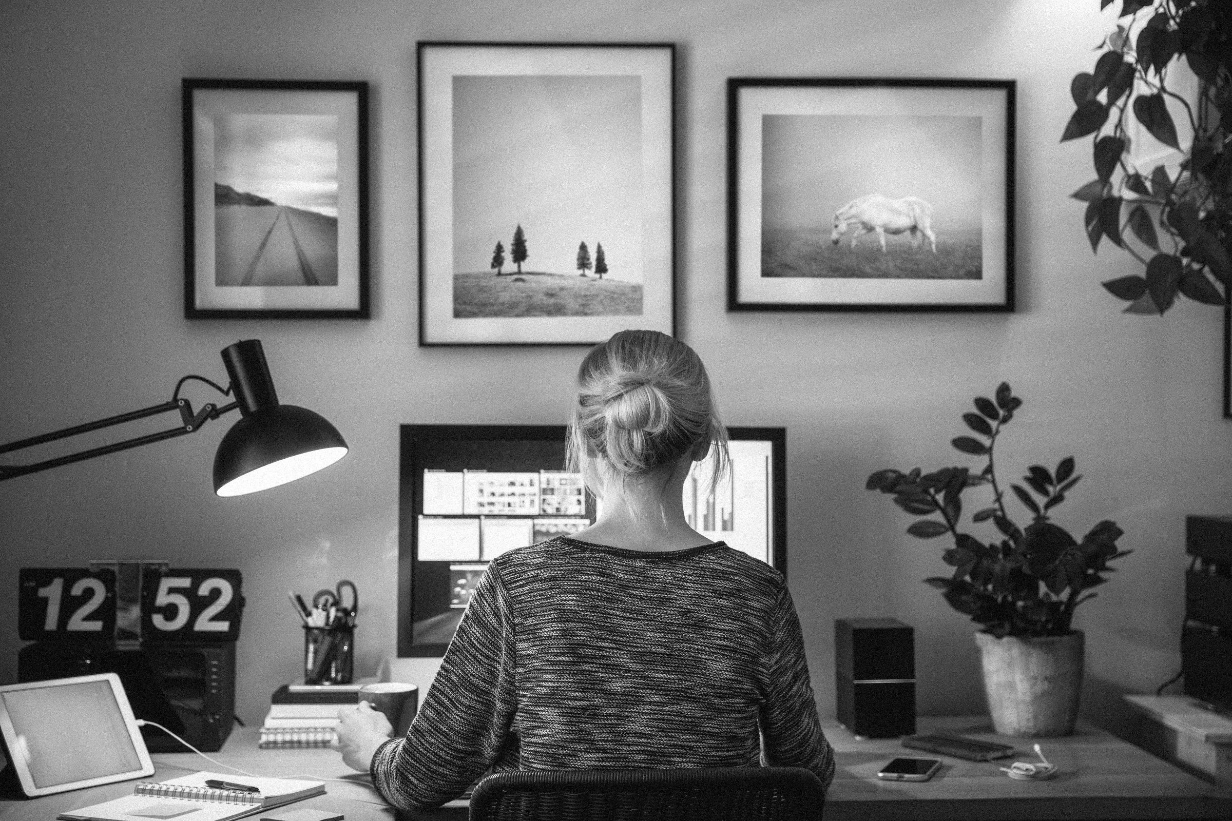 Someone working at a home desk with a monitor and an iPad